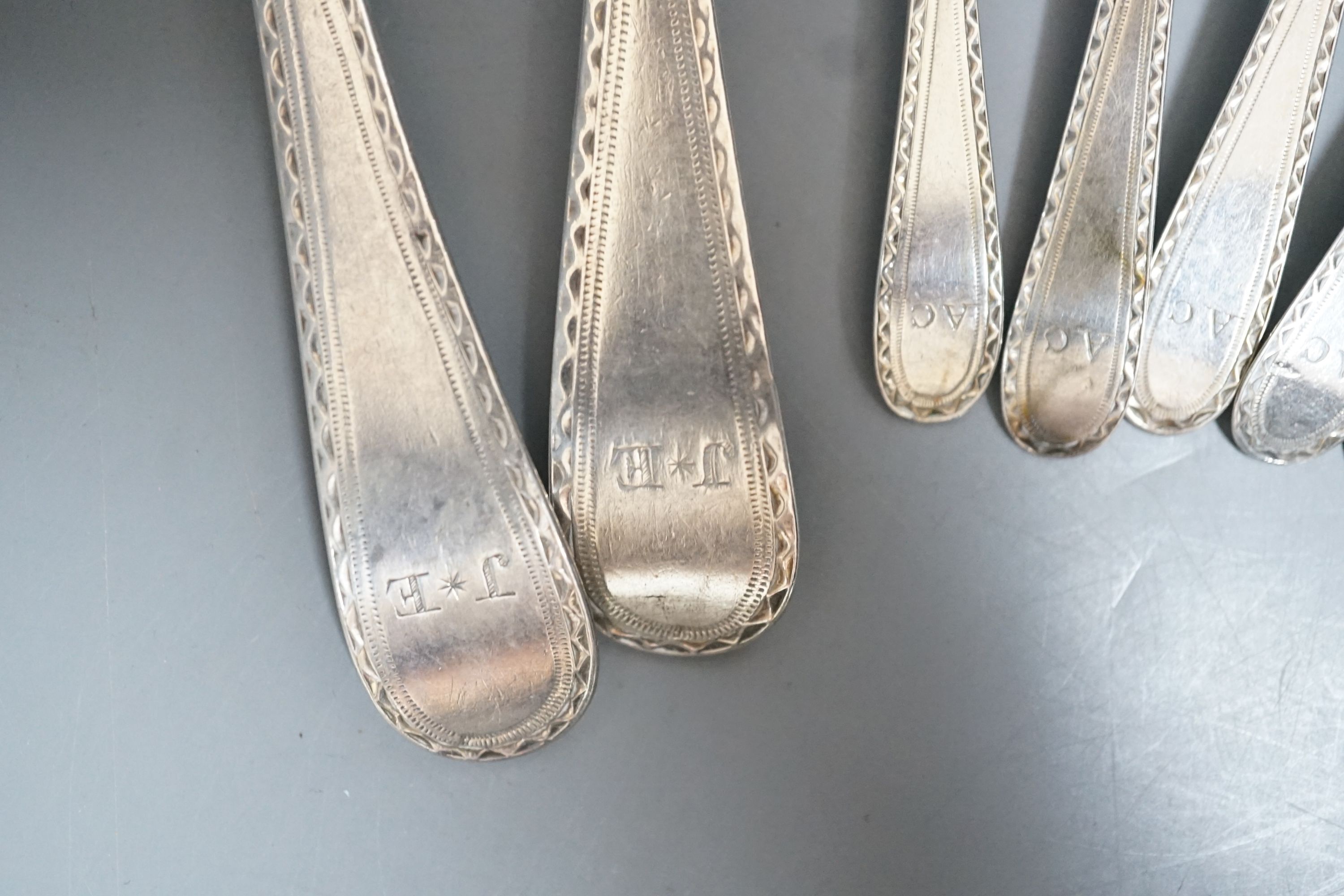 A set of silver George III bright cut engraved silver Old English pattern teaspoons, by Hester Bateman, no date letter and a pair of George III silver bright cut engraved Old English tablespoons, London, 1787